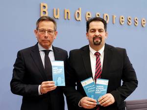 A droite, Aiman Mazyek, président du Conseil central des musulmans d’Allemagne (ZMD), aux côtés de Johannes-Wilhelm Rörig, présentent leur dépliant pour lutter contre les abus sexuels des enfants migrants.