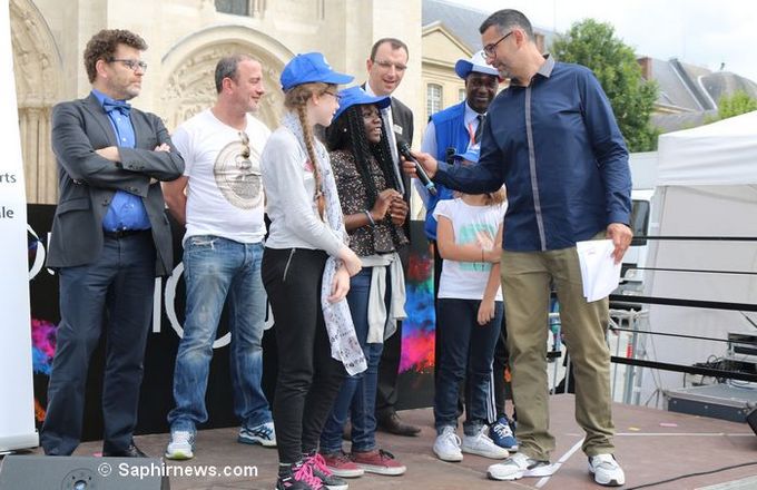 Après une douzaine de dictées des cités, la finale a été organisée à Saint-Denis le 10 juin à l'initiative de l'écrivain Rachid Santaki, ici tendant le micro à quelques uns des lauréats de l'Eurodictée à Saint-Denis.